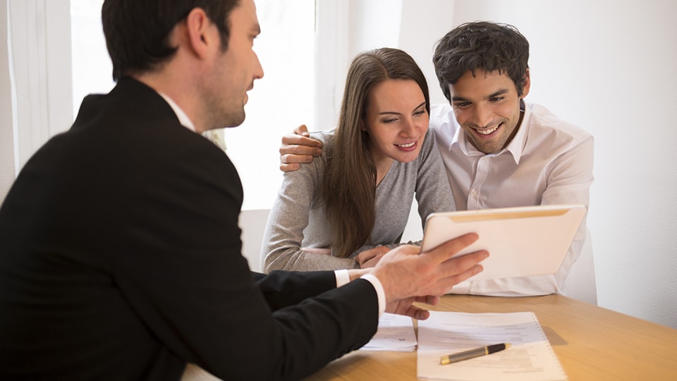 Young Couple meeting real-estate agent to buy property,
