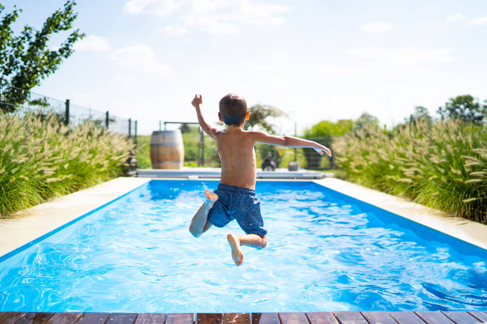 Kid jumping in pool