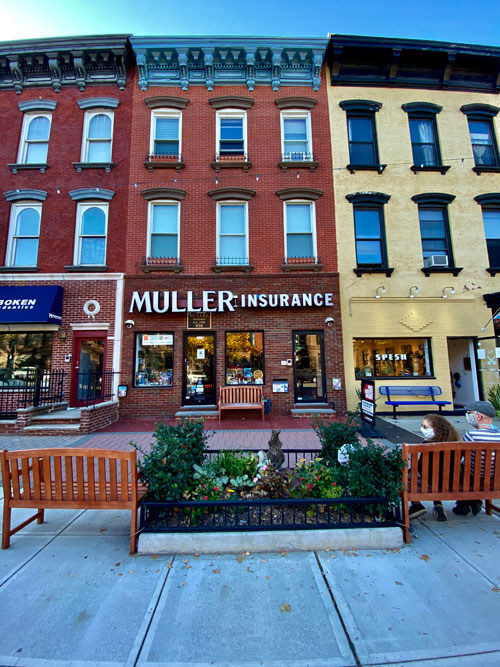 Muller Insurance front view with benches and small garden