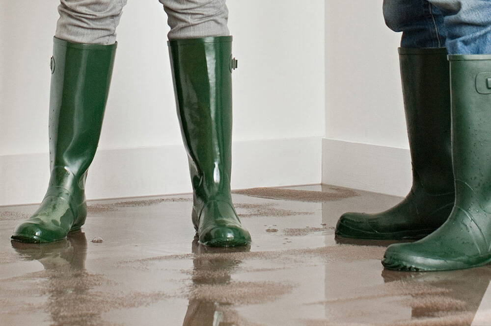 People wearing boots in a flooded room