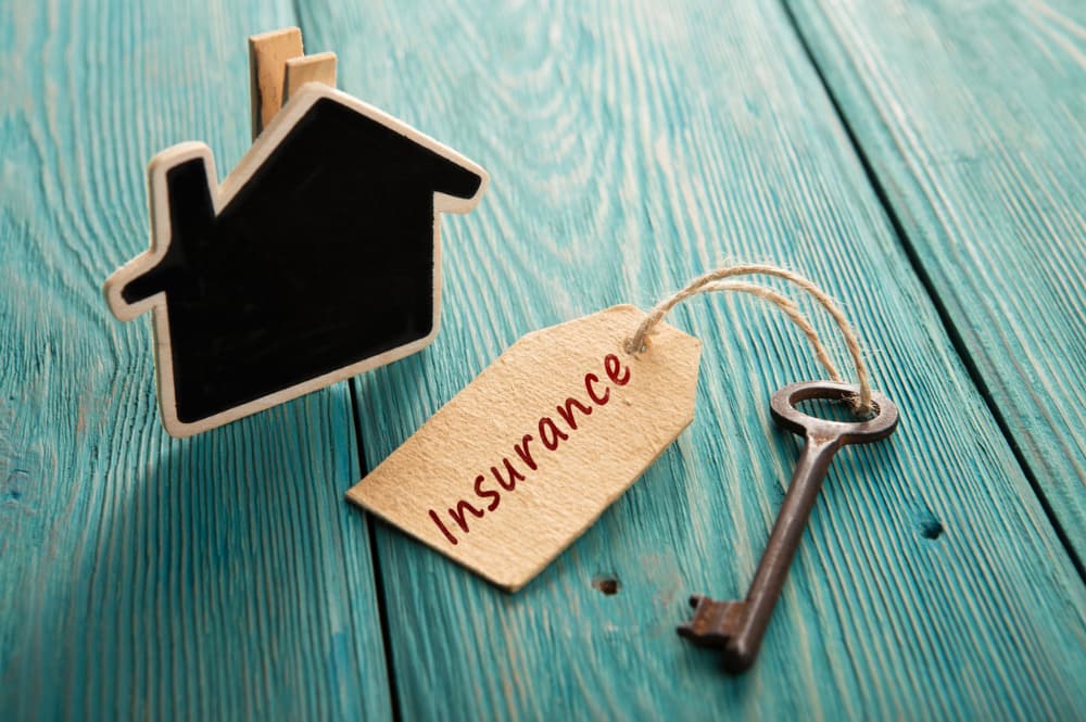 An illustration includes a house shape and a key with a tag that says “insurance".