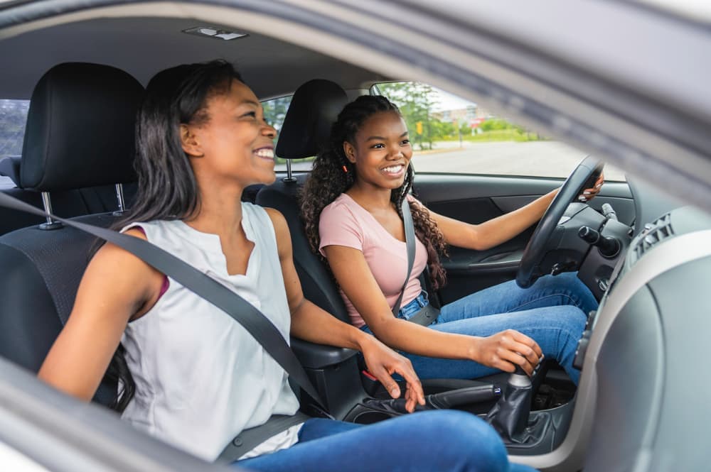 Teenager behind the wheel with a parent in the passenger seat