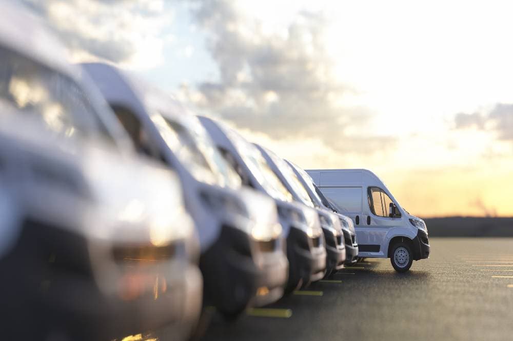 Commercial vans lined up in parking lot