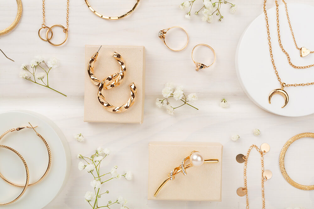 Jewelry items laying on white table.
