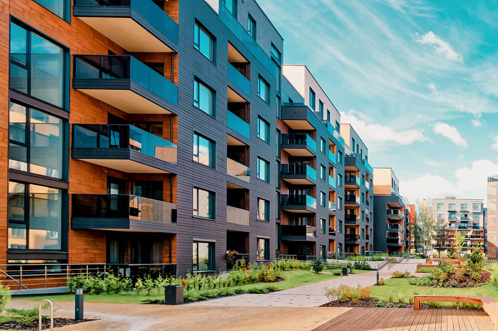 Exterior of condo building with walkway in the front.