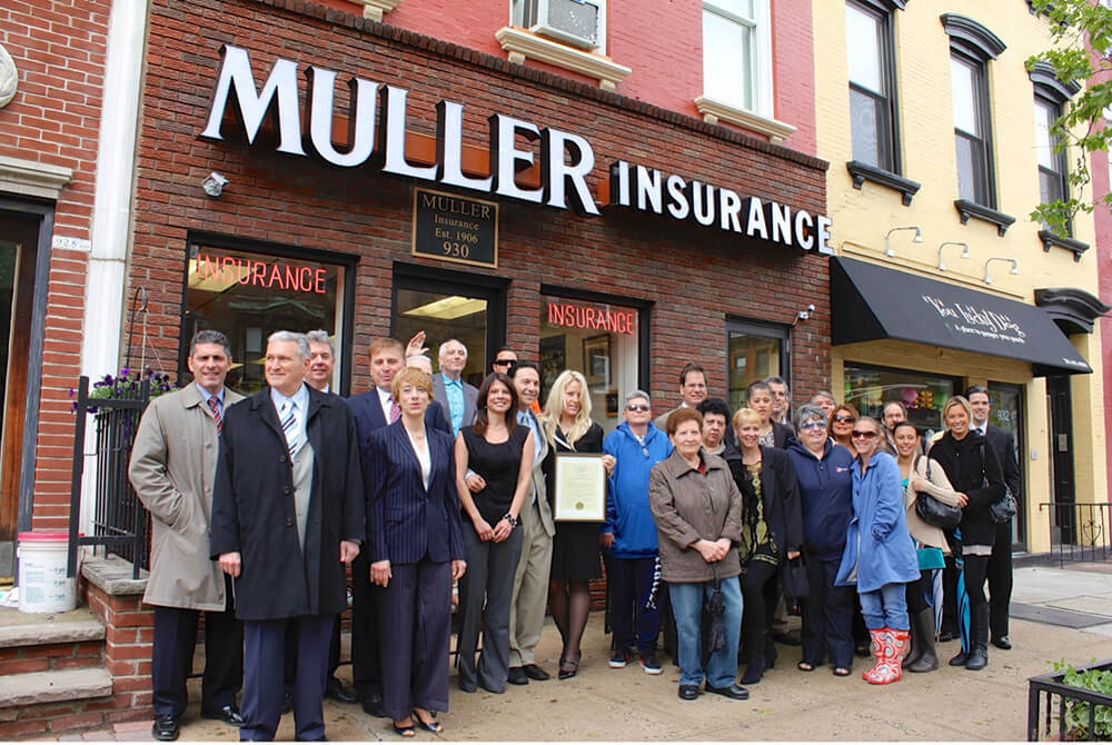 Muller Insurance business team of insurance agents in front of Muller Insurance office building