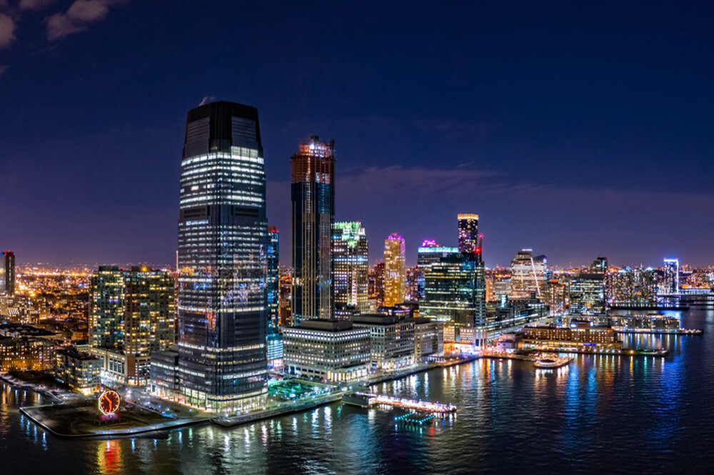 Night skyline of Hudson County NJ riverfront buildings